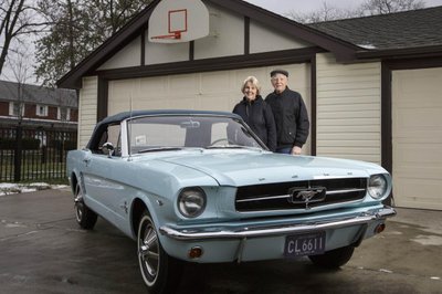 Tom-and-Gail-Wise-pose-with-her-Skylight-Blue-1964-1-2-Ford-Mustang-convertible.jpg